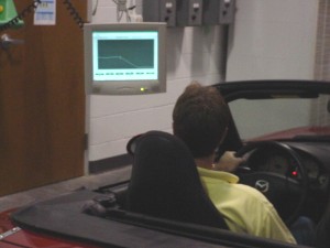 Photo: Driver watching computerized display showing test schedule and driving statistics